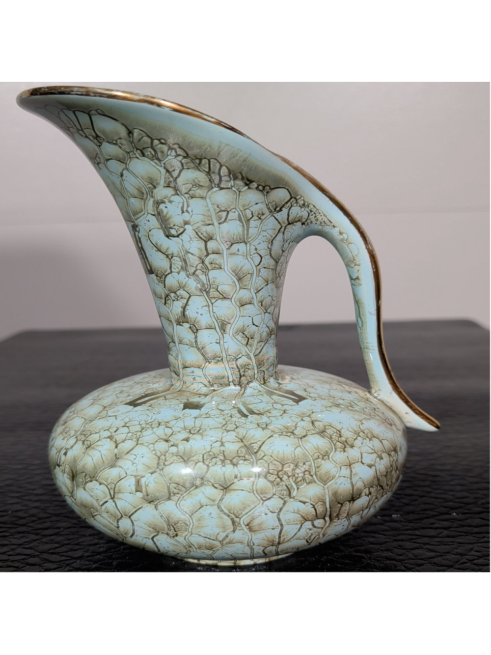 This is a vintage mid-century hand-painted Dutch pottery pitcher vase featuring